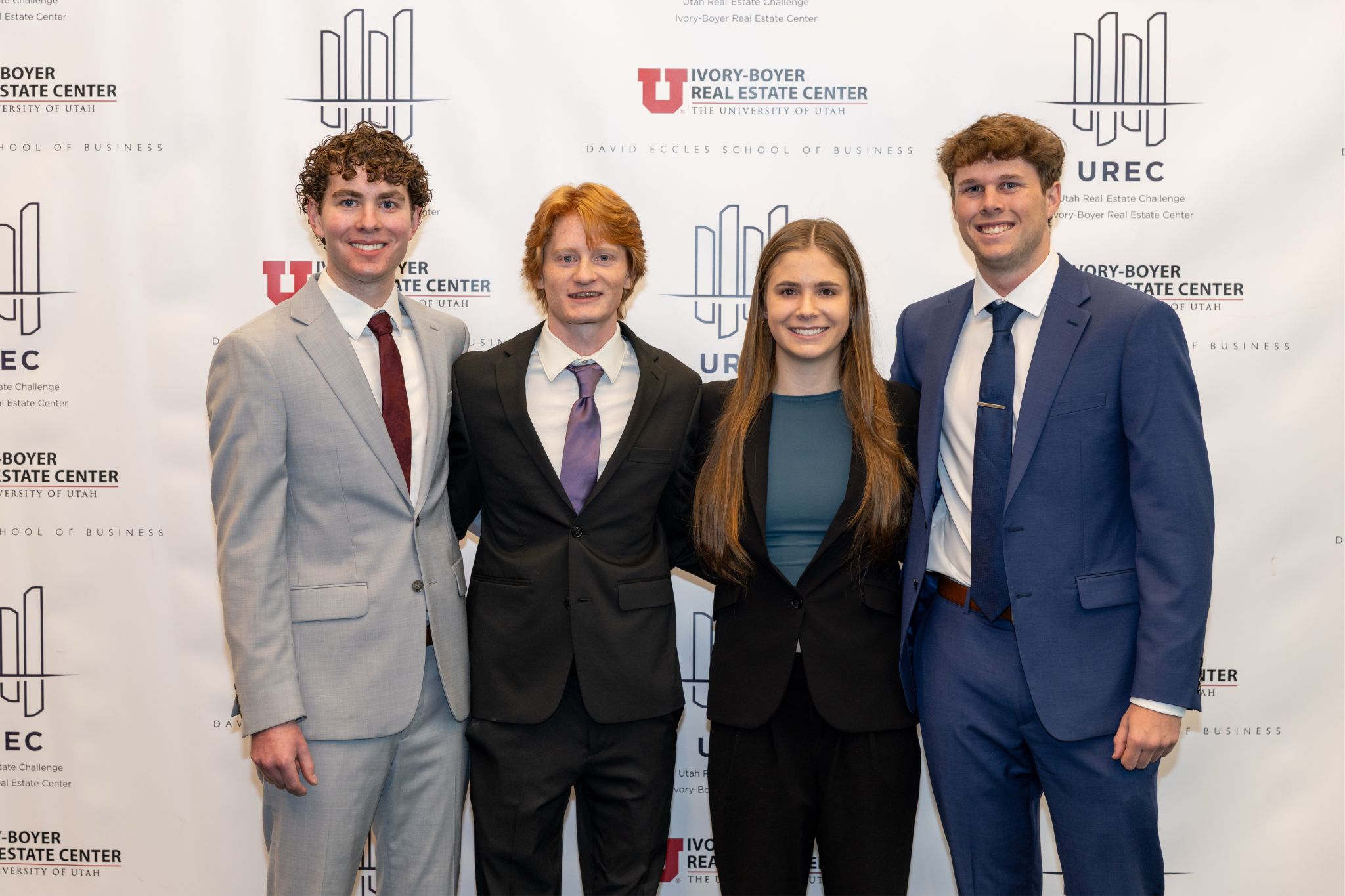 The Utah Real Estate Challenge team in front of the Ivory-Boyer Real Estate Center backdrop.